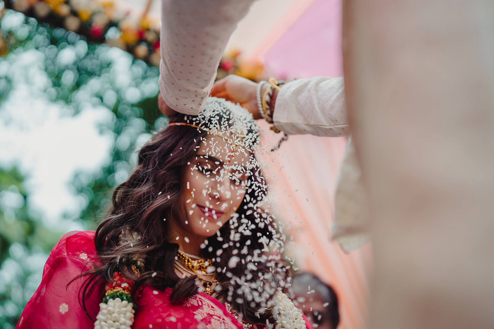 Groom adorns bride's head with rice in wedding ritual