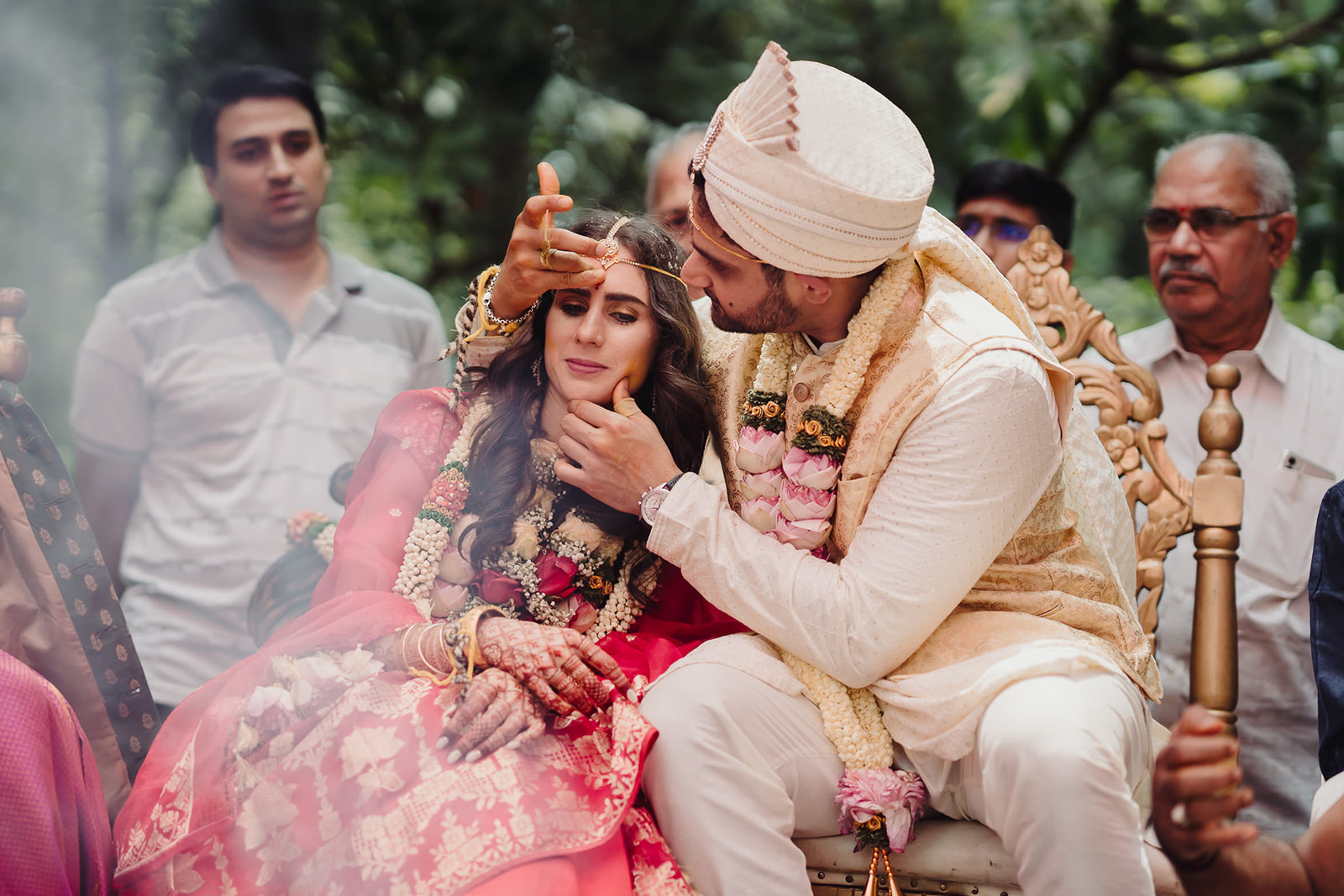 Groom adorns bride's forehead with sindur