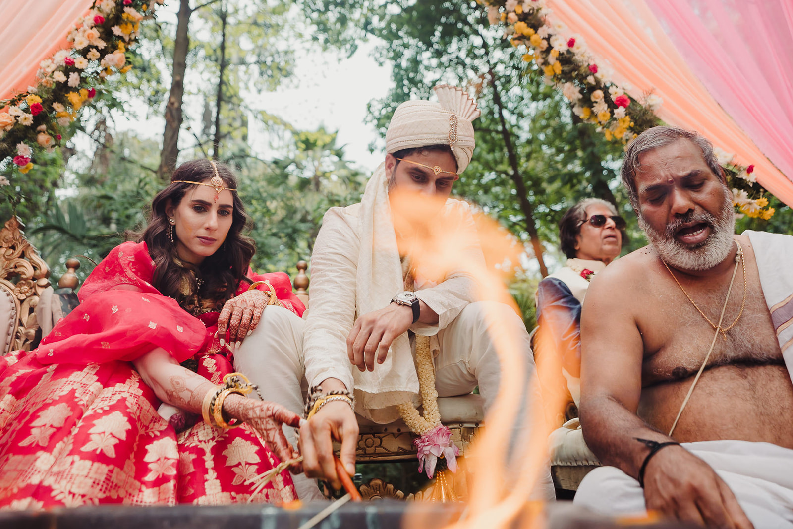  Bride and groom make offerings by the ceremonial fire