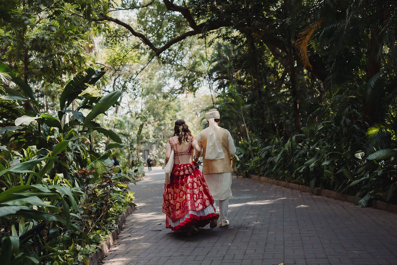 Newlyweds walk away, symbolizing the end of wedding rituals