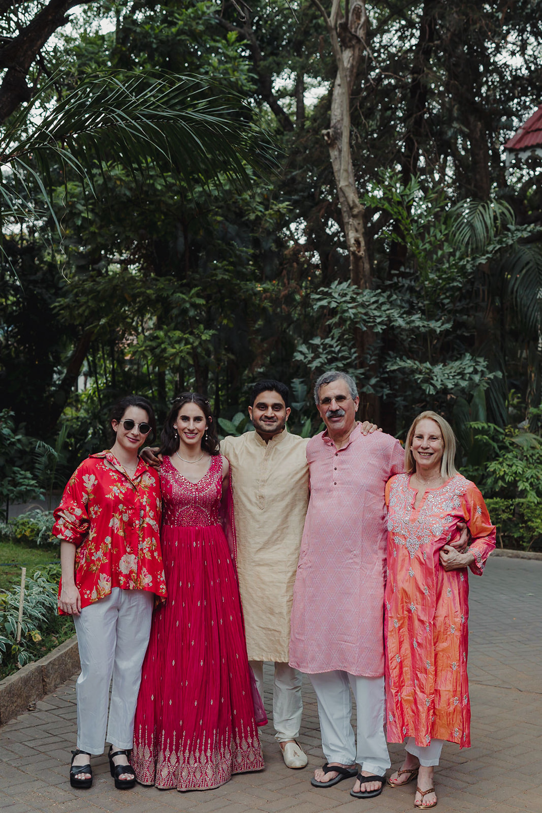 Surrounding the bride are her beaming family members, arranged in a semi-circle that exudes warmth and togetherness. 
