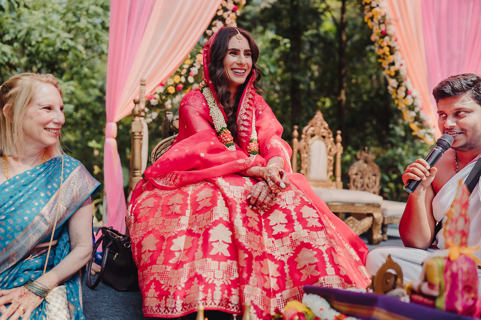 Bride captured in a candid moment while seated in the mandap