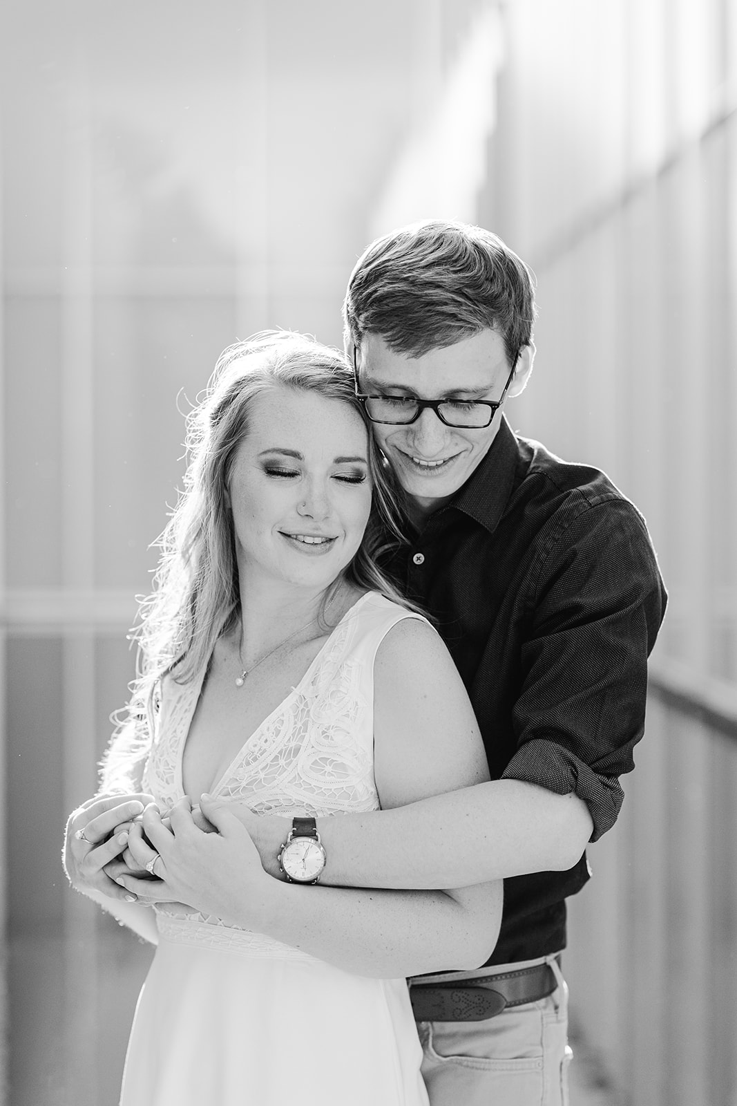 Couple hugging at the North Carolina Museum of Art in Raleigh for their spring engagement session