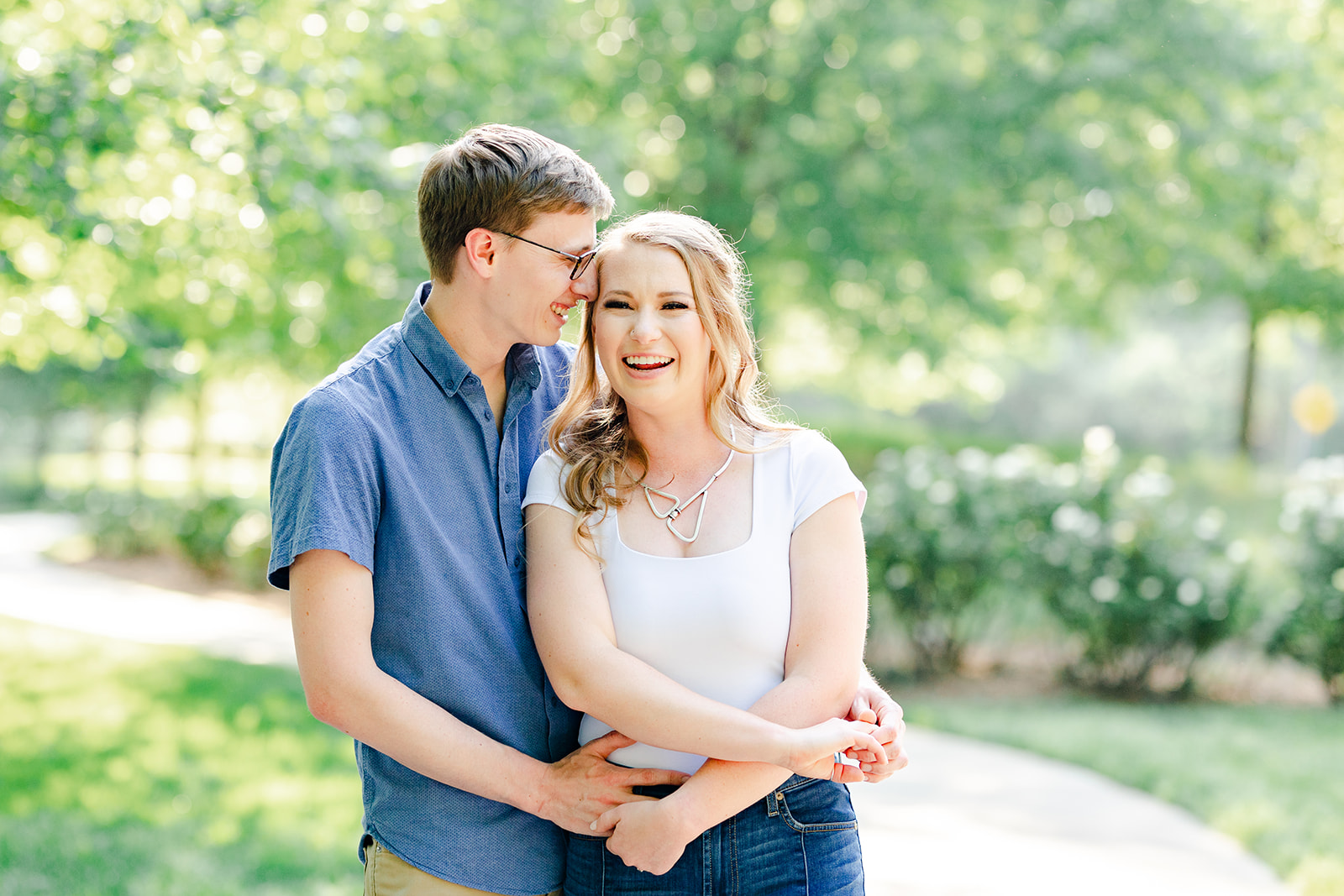 Couple laughing at the North Carolina Museum of Art in Raleigh for their spring engagement session