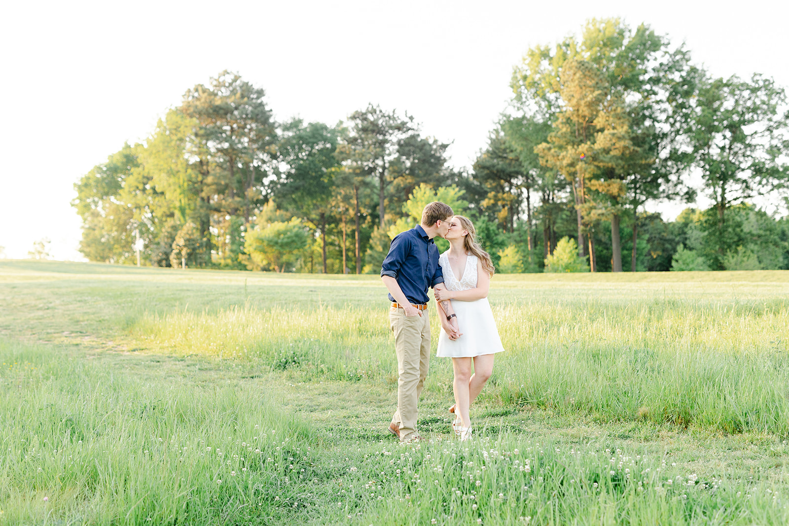 Couple walking at the North Carolina Museum of Art in Raleigh for their spring engagement session