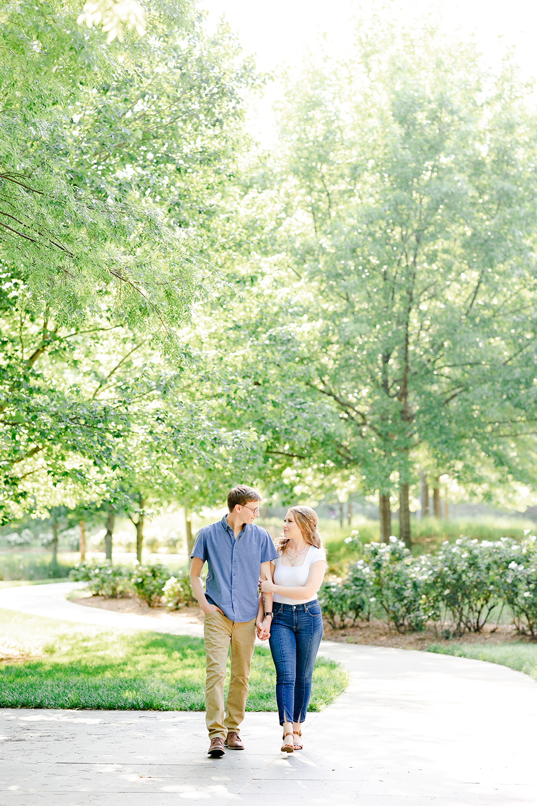 Couple walking at the North Carolina Museum of Art in Raleigh for their spring engagement sessions