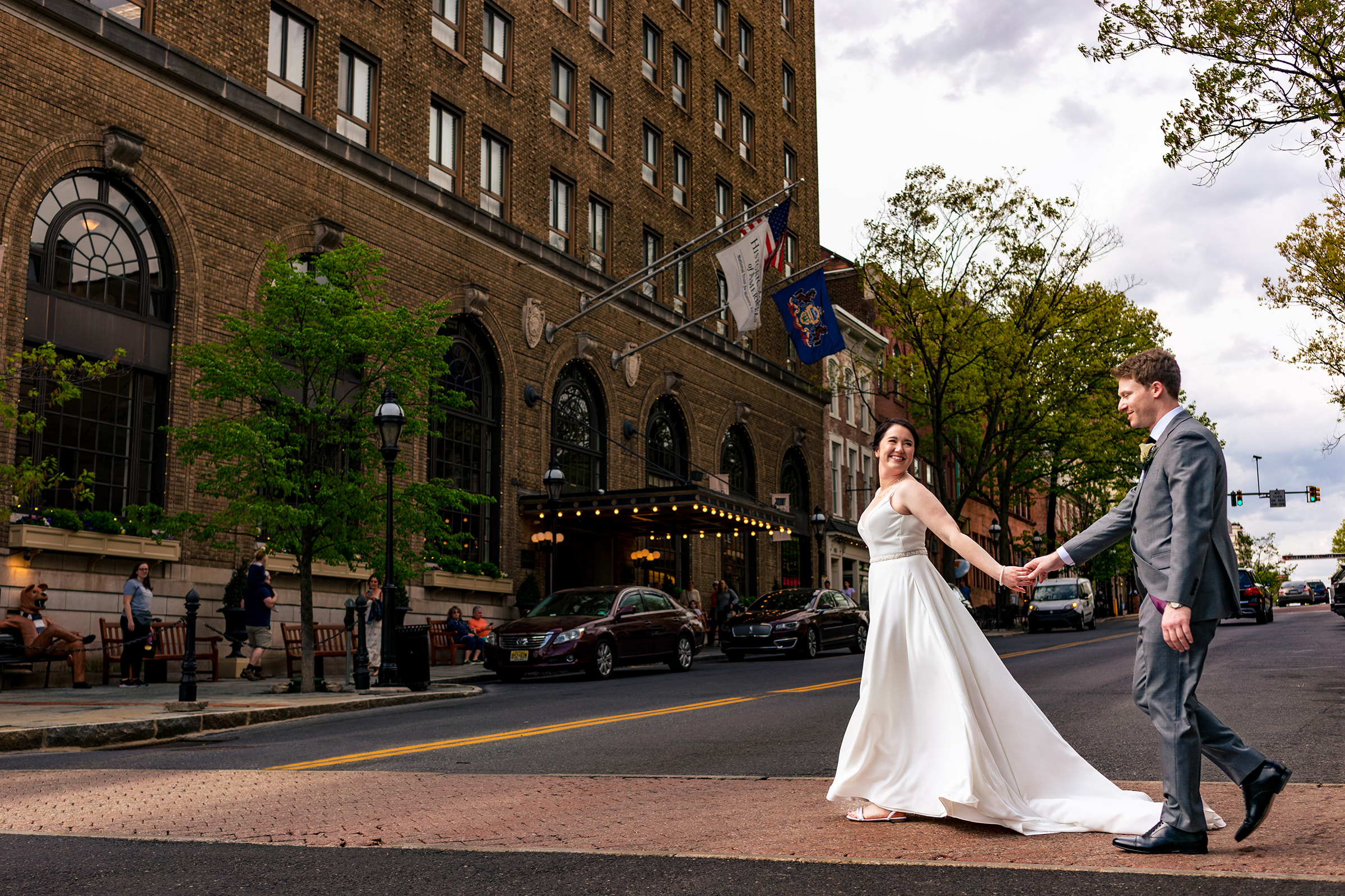 Wedding couple walking in front of the exterior of Hotel Bethlehem 