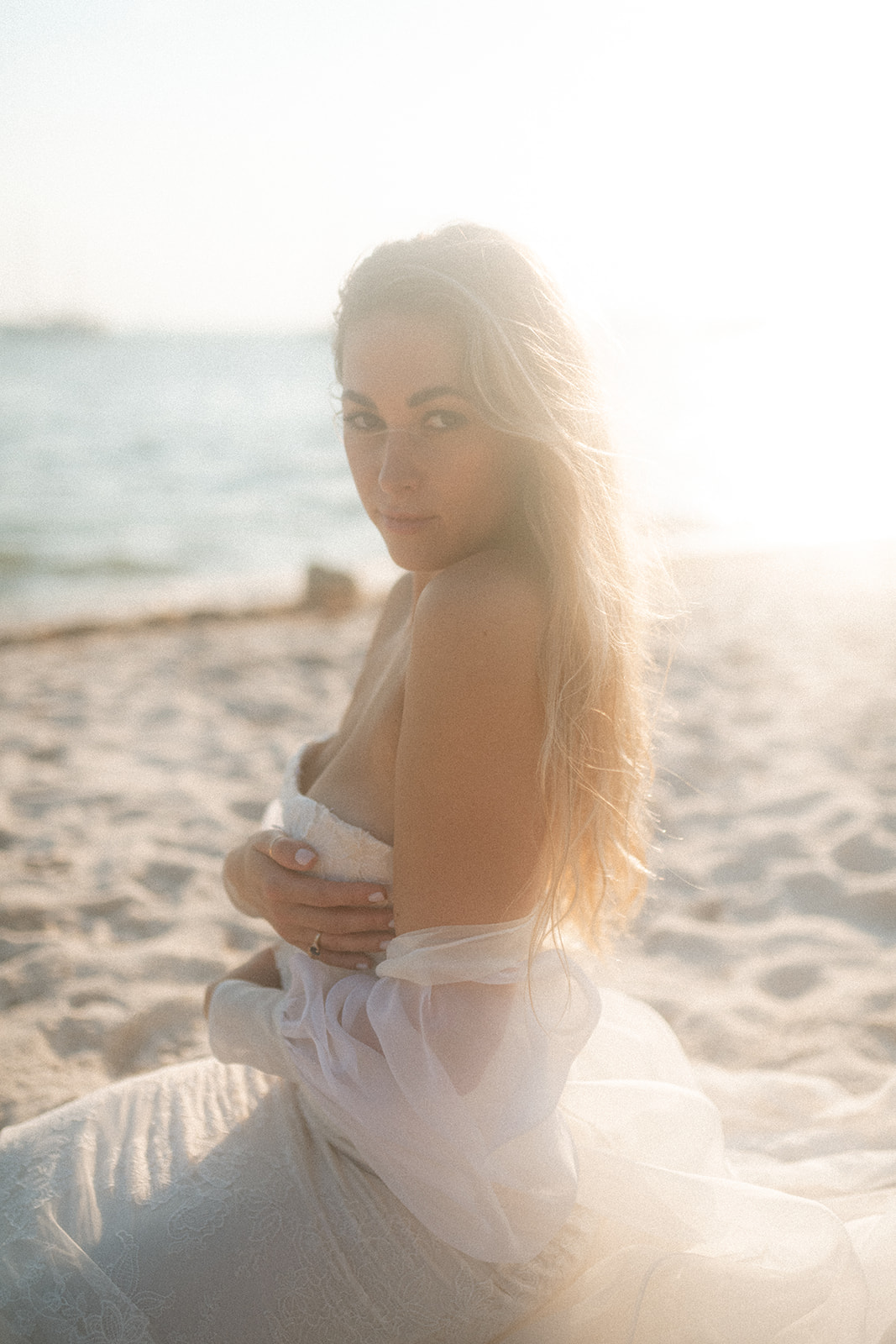 A couple who took their bridal portraits on the beach catch the most amazing sunset