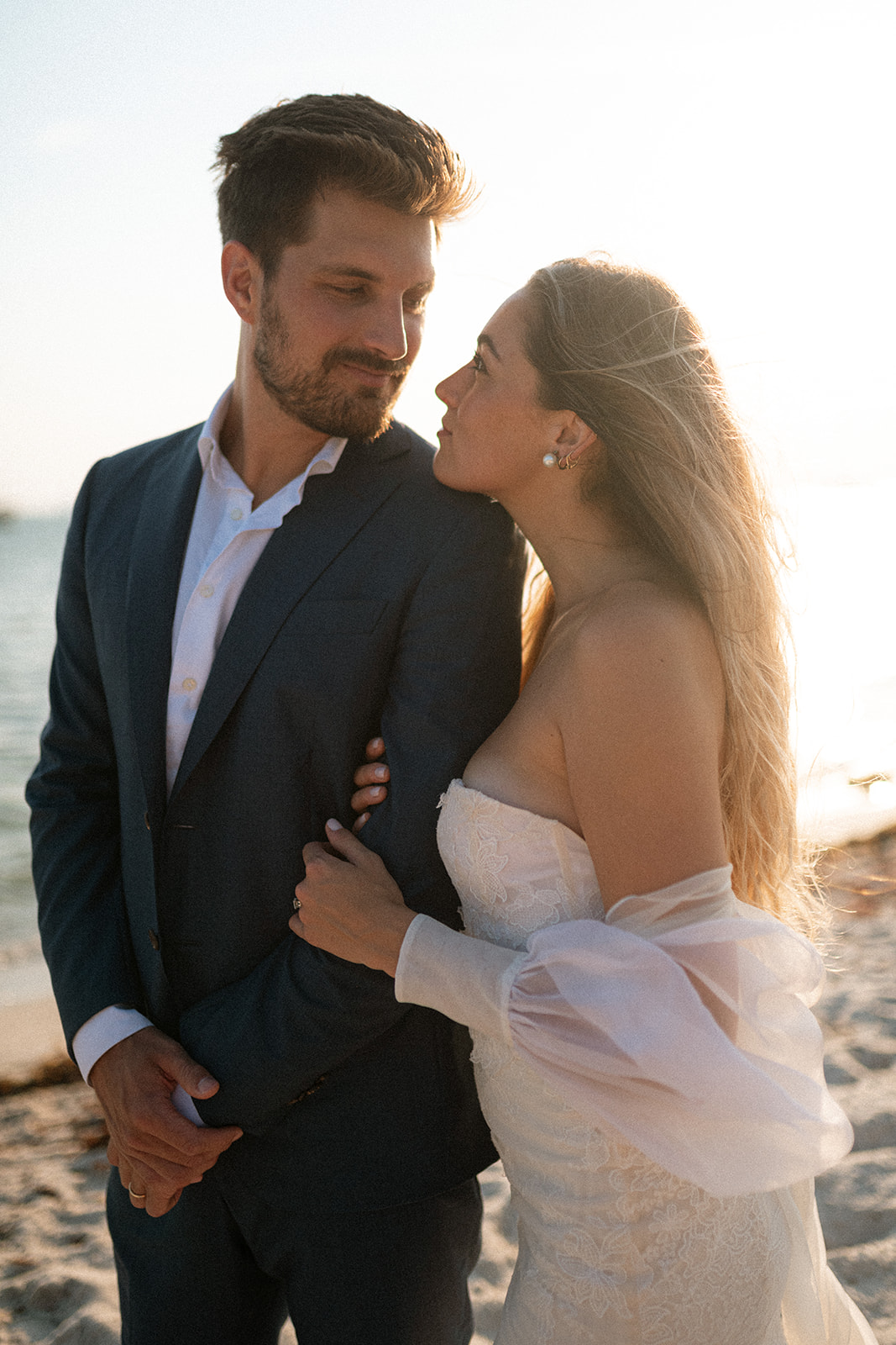 A couple who took their bridal portraits on the beach catch the most amazing sunset