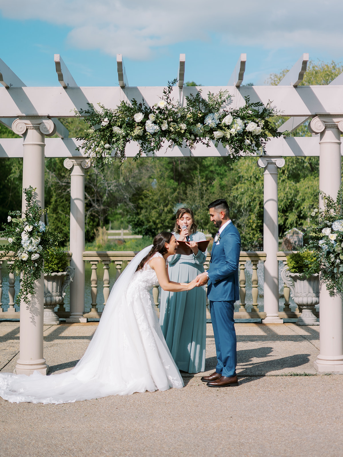 morais vineyard winery virginia bealeton wedding bride and groom putting rings on a line wedding dress blue suit gold 