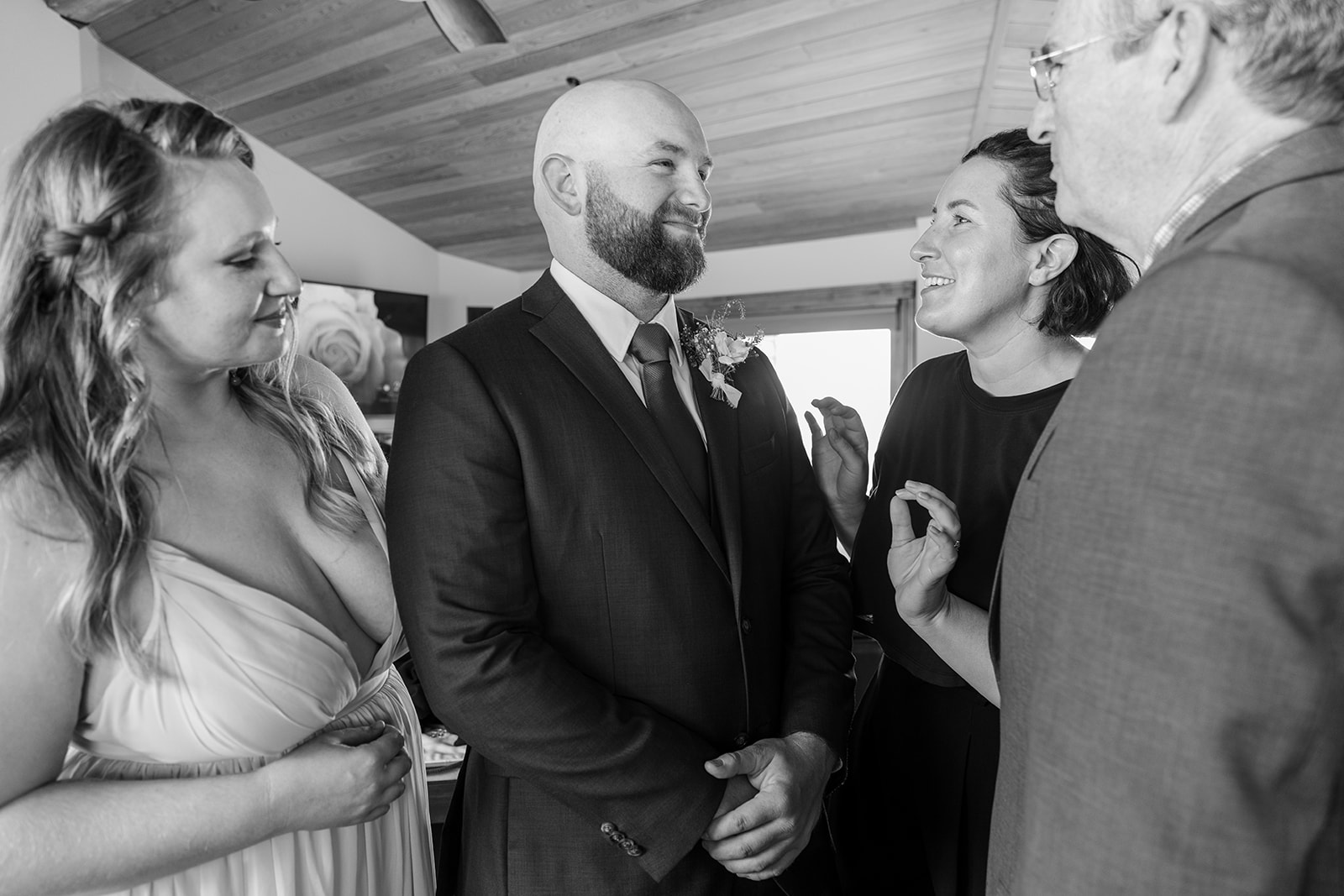 Groom and family pin boutonniere on groom before elopement ceremony in Lake Tahoe